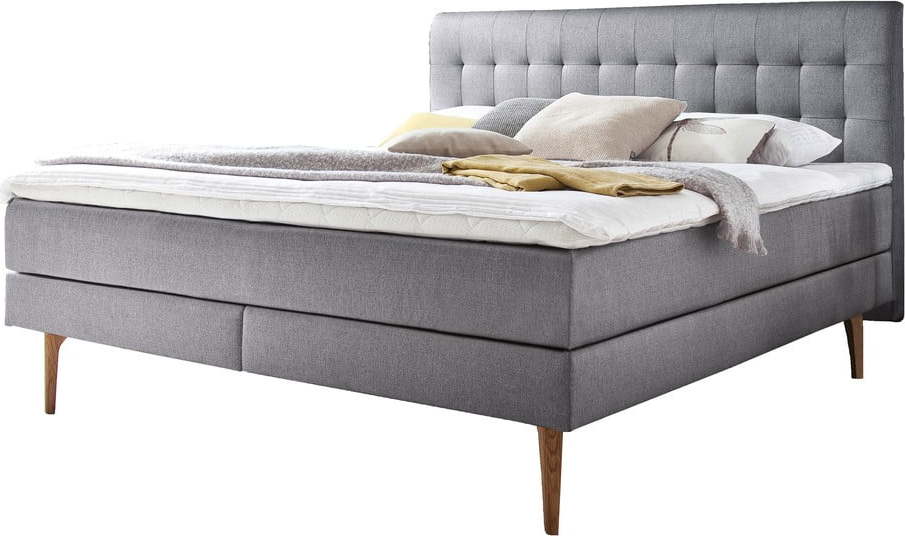 Světle šedá čalouněná dvoulůžková postel s matrací Meise Möbel Massello